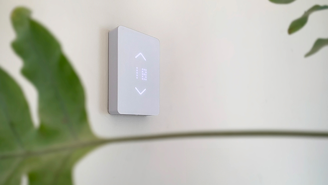 Mysa thermostat on the wall and plant Mysa thermostat on the wall and plant